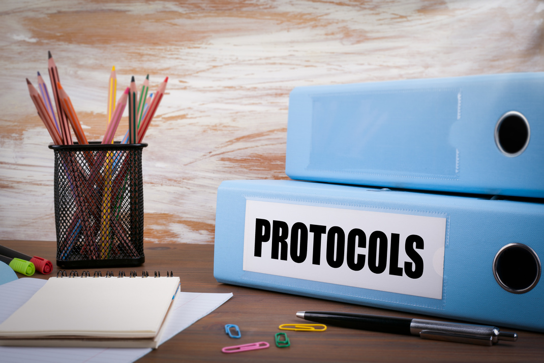 Protocols, Office Binder on Wooden Desk